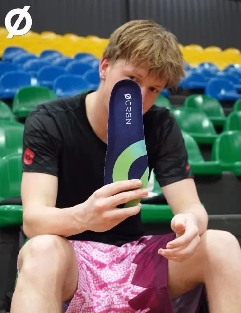Ethan Anderson holding a CRBN V2 insole