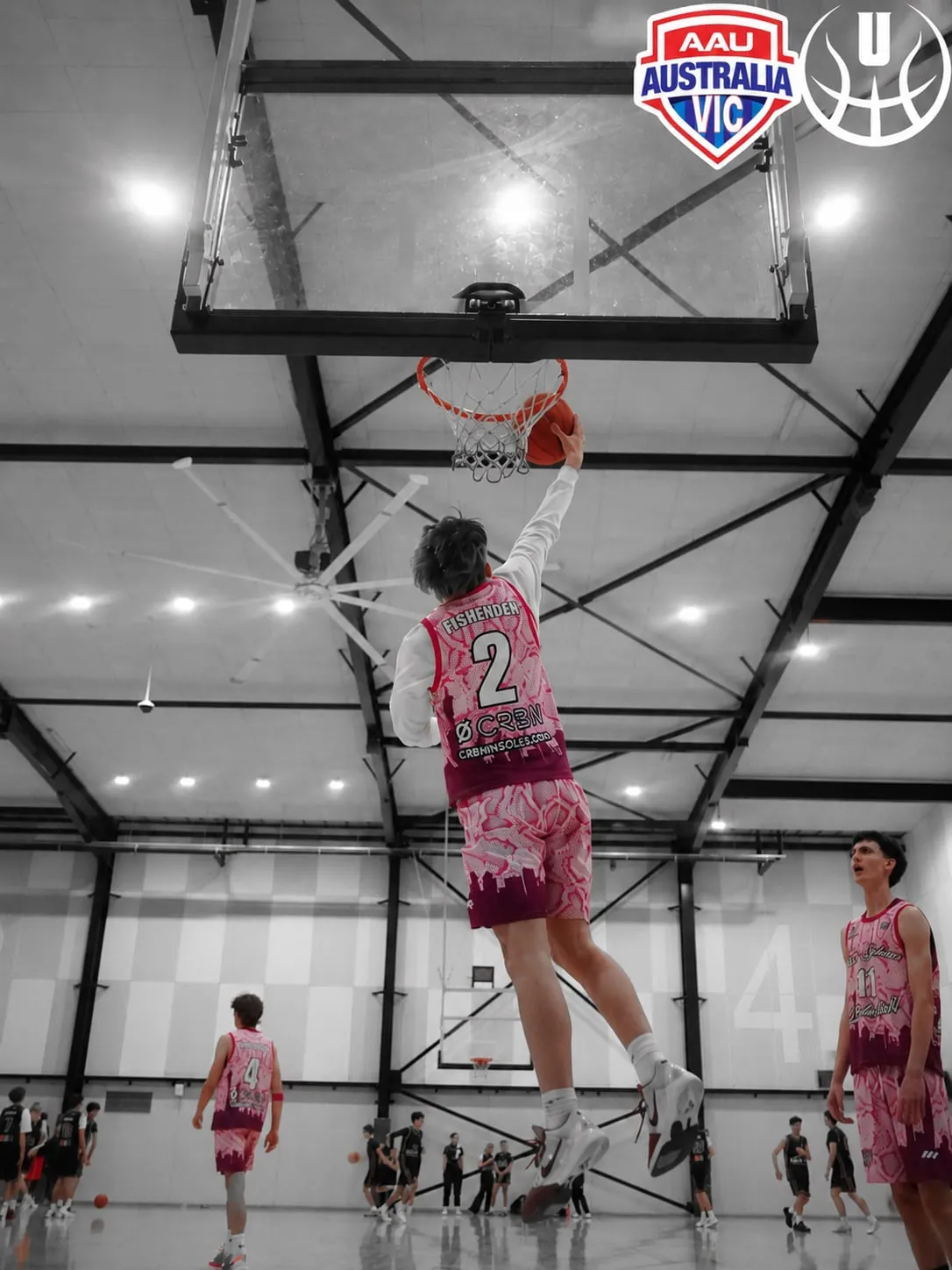 A Team Sphera player dunks mid-game in the CRBN-branded jersey at an AAU Victoria tournament